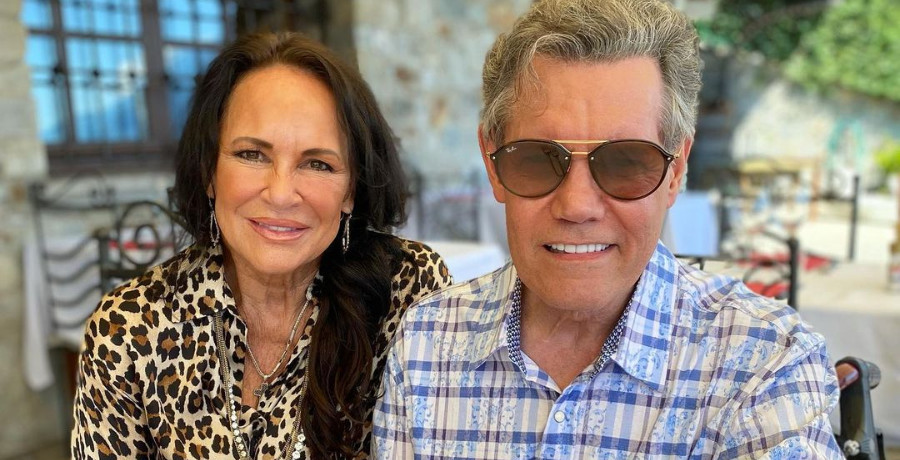 A woman with brown hair sitting next to a man in sunglasses