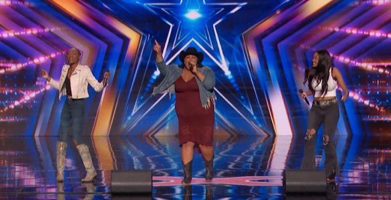 Three Black women on a stage