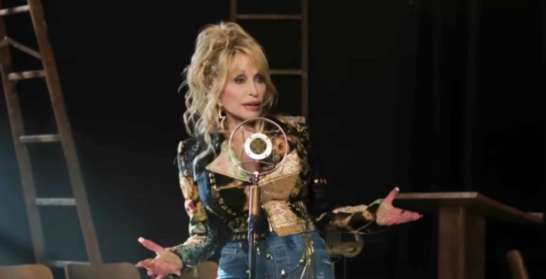 A woman with blonde hair singing into a microphone